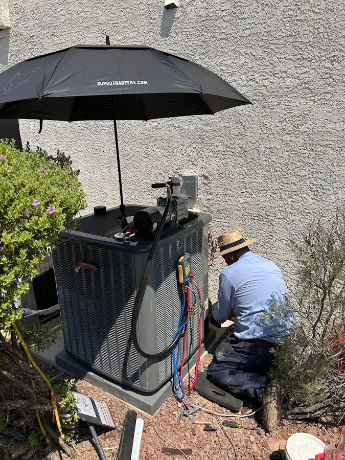 HVAC technician performing outdoor AC maintenance in Midwest City